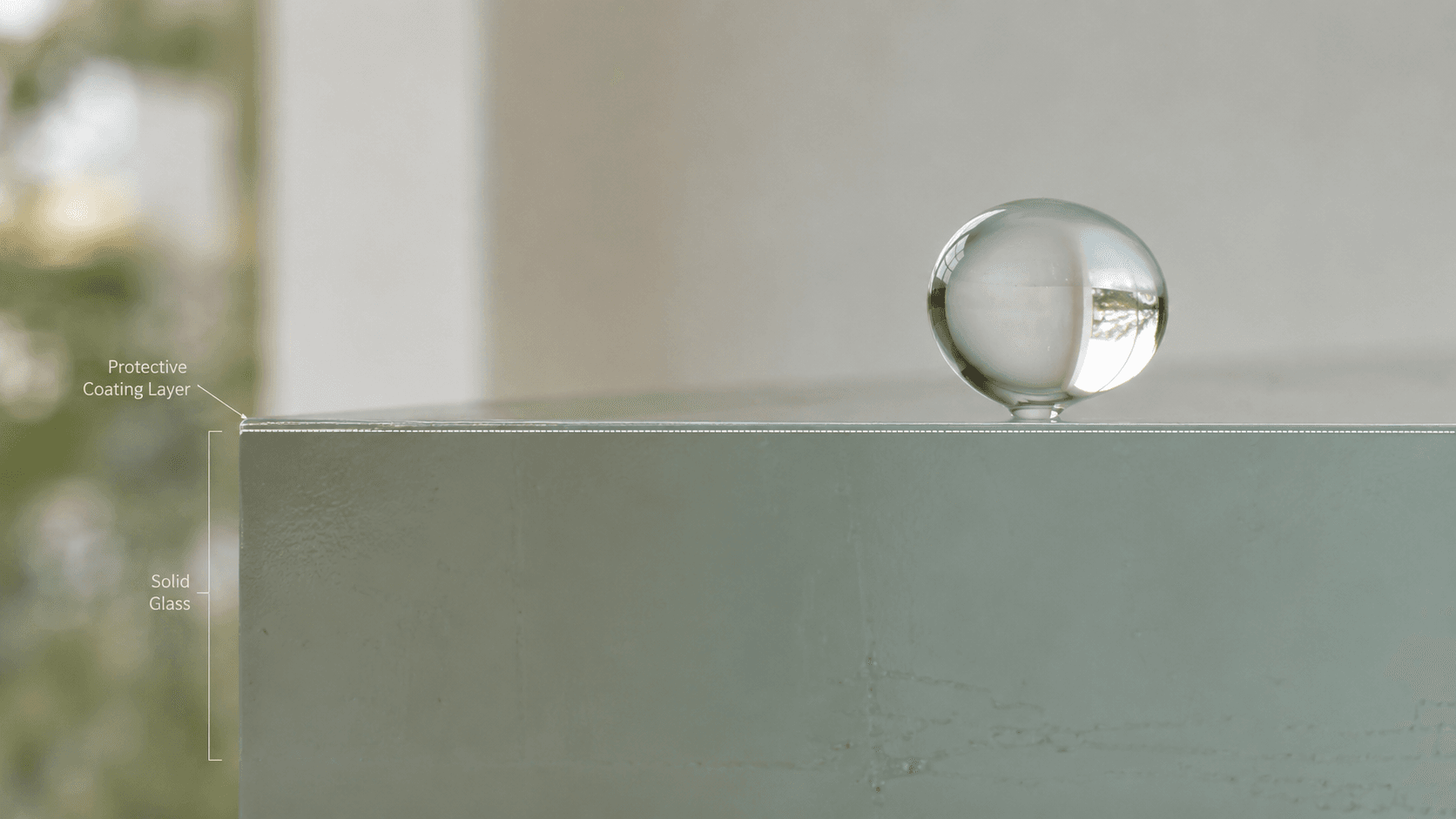 Cross-section illustration: glass surface, the invisible two-molecule-thick EnduroShield bonded layer, and a water droplet rolling off