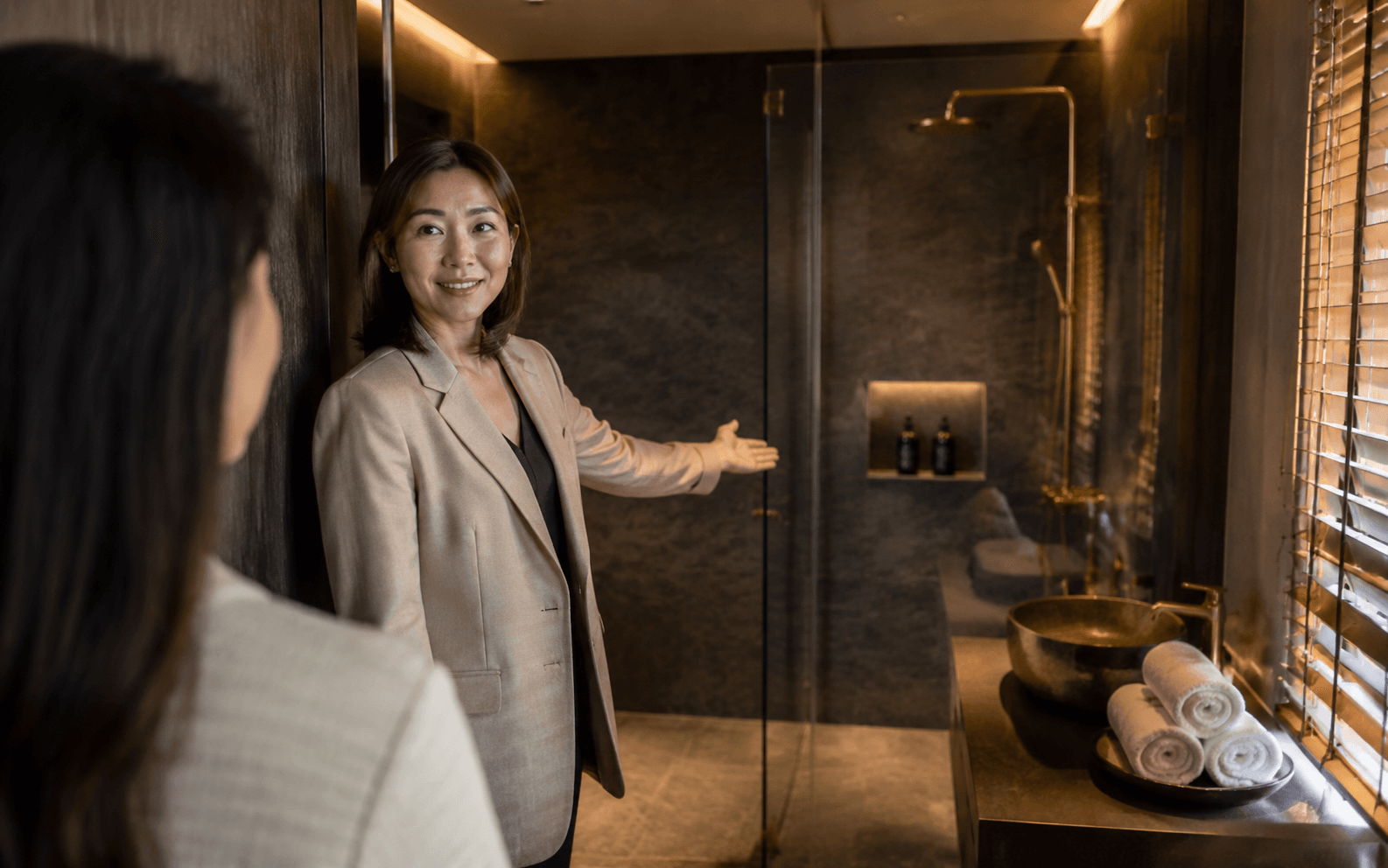Hotel-grade crystal-clear glass shower in a styled Airbnb bathroom