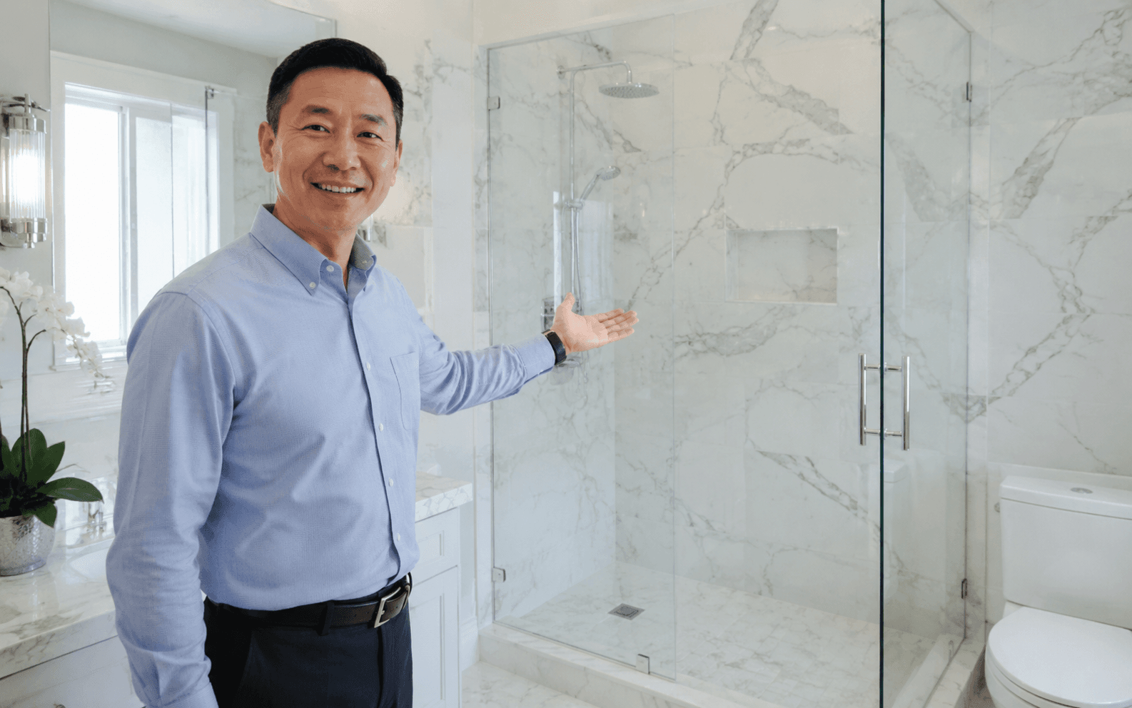 Prospective home buyer viewing a like-new bright bathroom, clear glass shower