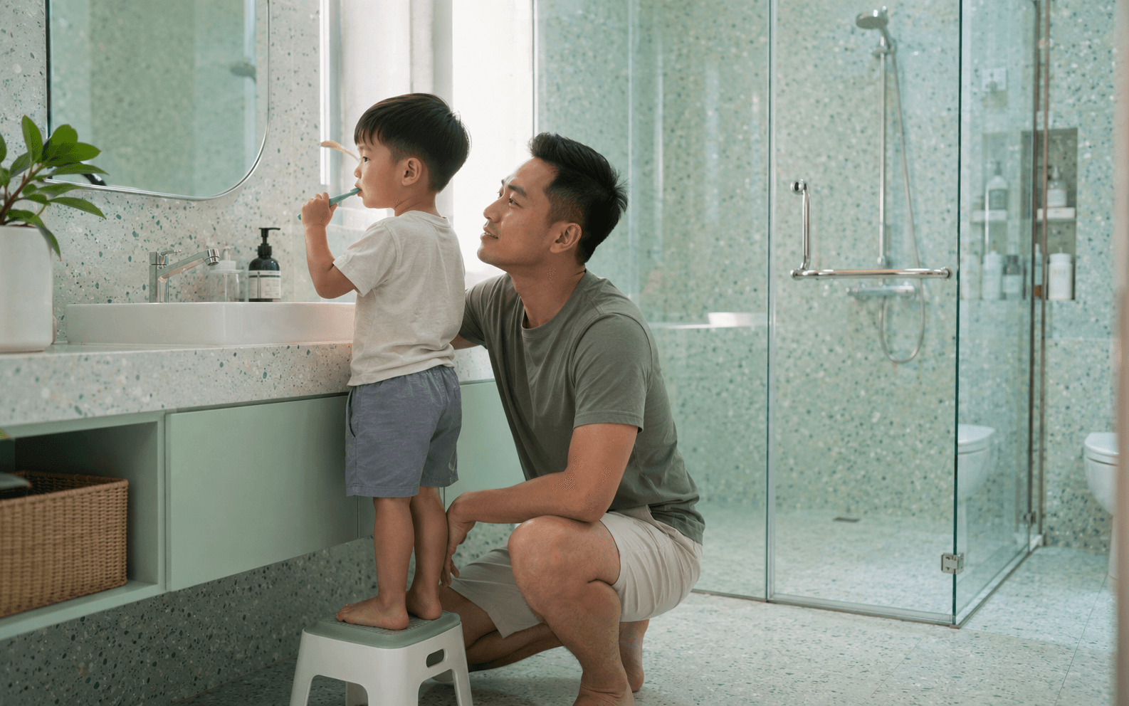 Young family bathroom, toddler hand on clean clear glass, warm clean home feeling
